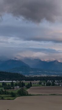 Beautiful Fraser Valley Landscape with Chilliwack Townsite Under Cloud-Covered Mountains in British Columbia, Canada
