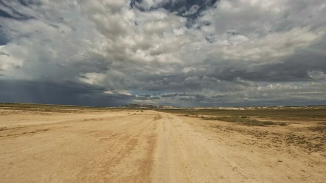 Driving forward on a dirt road through arid landscape