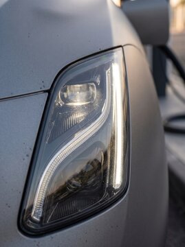 Close-up of modern LED headlight on a heavy duty electric truck GENERATED AI