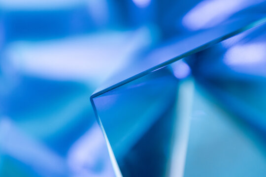 Blue abstract glass panel with reflective geometric surface