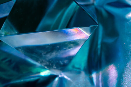 Abstract blue prism crystal with iridescent light refraction