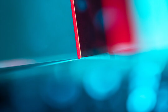 Abstract red geometric edge on cyan illuminated background