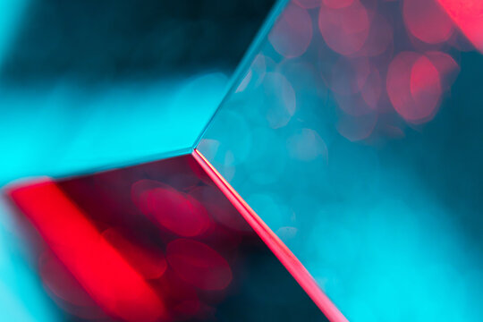 Abstract mirror reflection with cyan and red bokeh lights