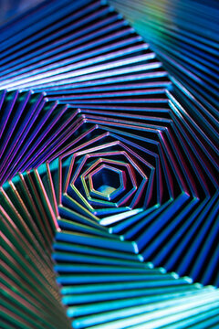 Neon geometric spiral tunnel in abstract metallic pattern
