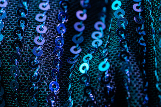 Blue sequin fabric texture with sparkling abstract pattern