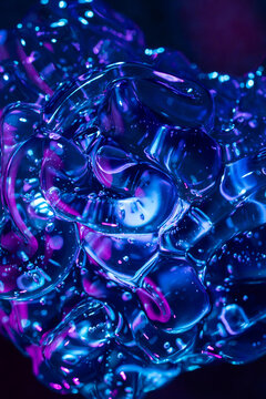 Abstract blue and magenta gel texture with glossy bubbles