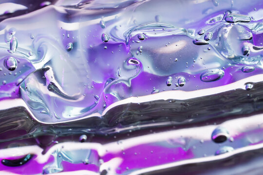 Abstract translucent liquid texture with violet reflective glow
