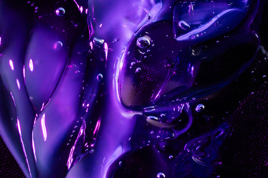 Abstract purple liquid glass texture with glowing bubbles