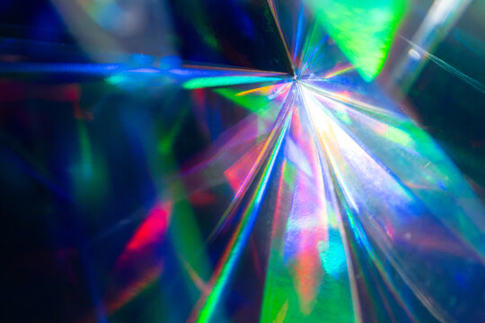 Futuristic prismatic light burst on dark tech background
