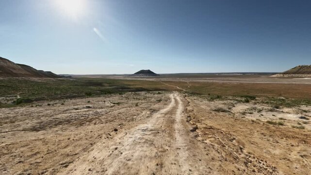 Forward Motion on Dirt Road Through Arid Landscape
