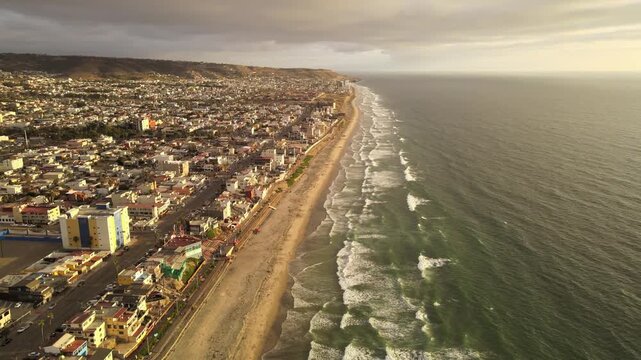 Aerial drone view of Playas de Tijuana coastline and Pacific Ocean waves in Baja California Mexico