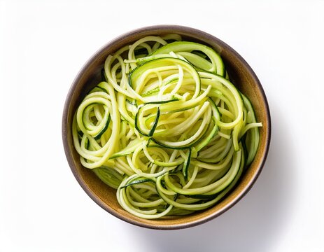 zucchini noodles on bowl isolated on white background top view