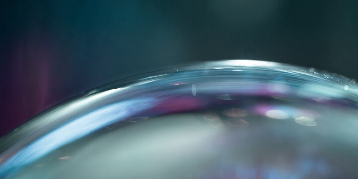 Abstract iridescent glass curve with soft blue reflections