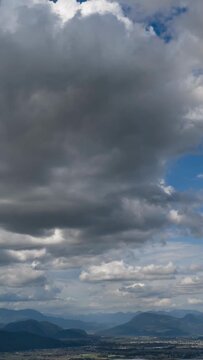 Dramatic Cloudscape Over Chilliwack, British Columbia's Fraser Valley with Moving Clouds and Majestic Mountains