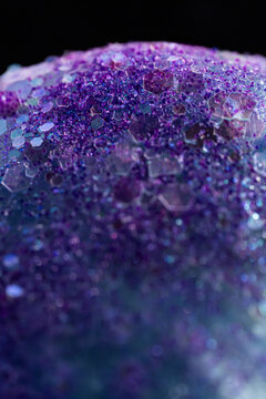 Purple hexagonal glitter texture on dark abstract background