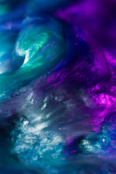 Abstract teal and purple fluid texture with luminous swirls
