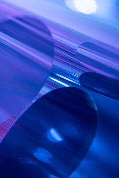 Abstract curved metallic shapes with blue and purple light
