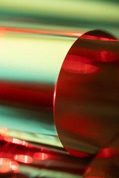 Abstract red and green light on reflective metal cylinder
