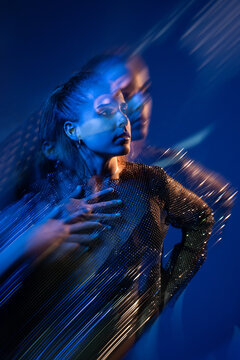 Woman portrait with motion blur and blue neon light