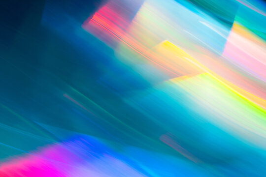 Abstract neon light trails in vibrant blue and rainbow hues