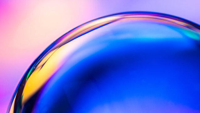 Iridescent glass sphere with vibrant blue abstract reflection