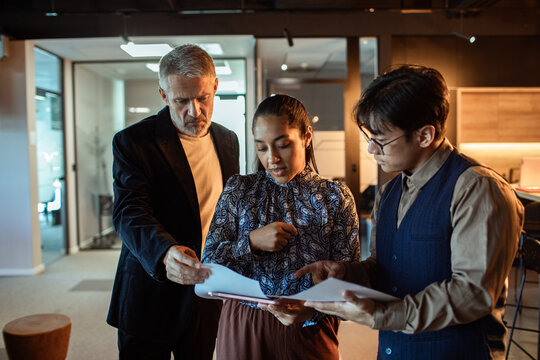 Diverse team reviewing documents in modern office
