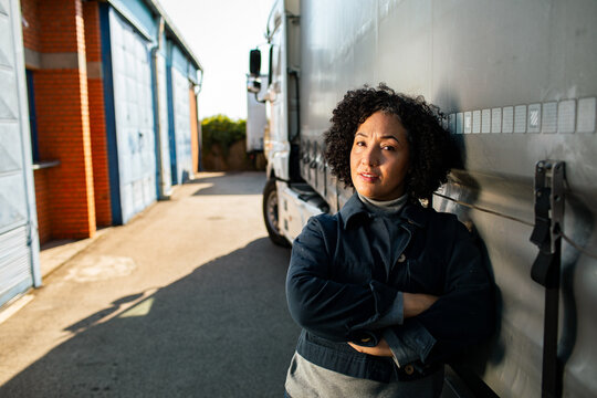Confident female truck driver at logistics depot