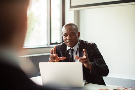 Confident business executive explaining strategy during office meeting