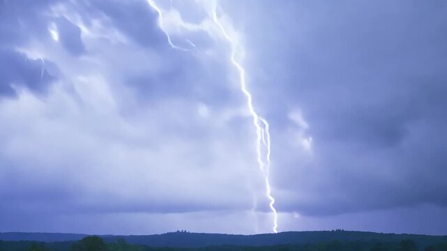 Dramatic lightning strikes over rural landscape