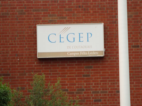 Gatineau, Quebec, Canada &ndash; July 04, 2026: An outdoor view showing a rectangular institutional wall sign for "C&eacute;gep de l'Outaouais Campus F&eacute;lix-Leclerc" mounted on red brick on Bd de la Gappe.
