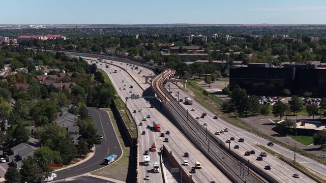 Aerial of major transportation corridor through Aurora Colorado with public rail lines in summer along Interstate 225 and Parker Road