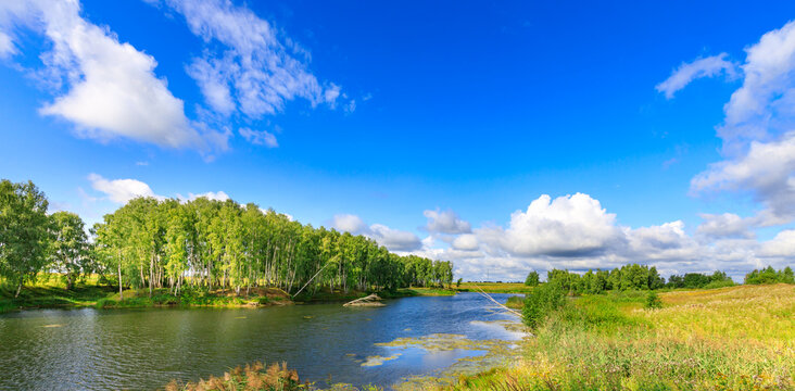 Summer landscape with river, trees, and sky