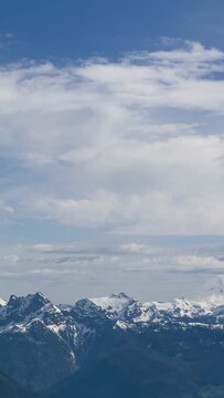 Majestic Snow-Capped Mountain Range Under a Vast Blue Sky in British Columbia, Canada