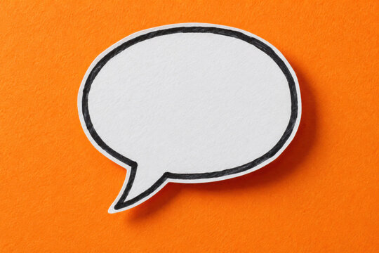 White blank speech bubble icon with black outline on bright orange background. Empty comic chat bubble for text message. Simple graphic element for communication, marketing, business presentation.