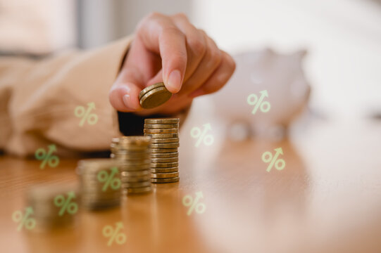 Saving money concept. Young girl's hand put coin on coins stack. Financial growth, investment, wealth management, budgeting, economic planning and longterm stability for personal finance success.