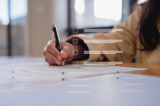 Close up young businesswoman hands writing pen on paper. hands writing planing meeting agenda on wooden table. Close up hand write using pen note Personal Organizer sign contrac