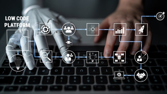 Futuristic Robotic Hand and Human Hand Collaborate on Laptop with Low Code Platform Graphics and Icons for Technology and Innovation Concepts Quark.