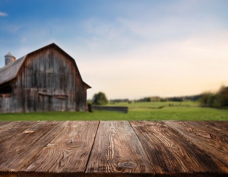 rustic wood board empty mockup table surface with vintage wooden barn on a farm background