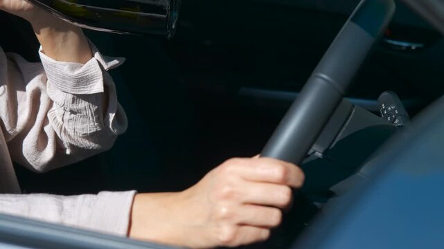 Woman drinking alcohol while driving a car. Close-up revealing businesswoman drinking wine while driving, displaying dangerous, irresponsible behavior compromising road safety and personal well-being