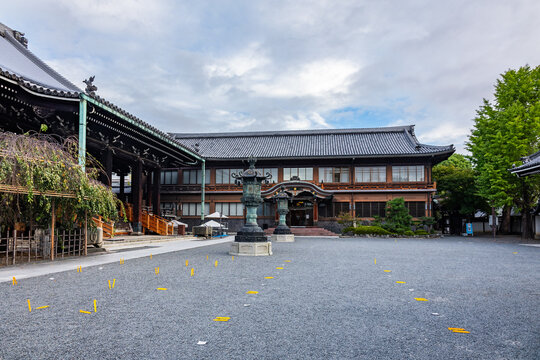 Monumental wooden temple building at Higashi Honganji in Kyoto beneath overcast dramatic sky, Kyoto, Japan 