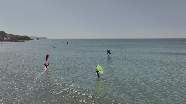 Windsurfers over Bantham Beach and River Avon from a drone, South Hams, Devon, England