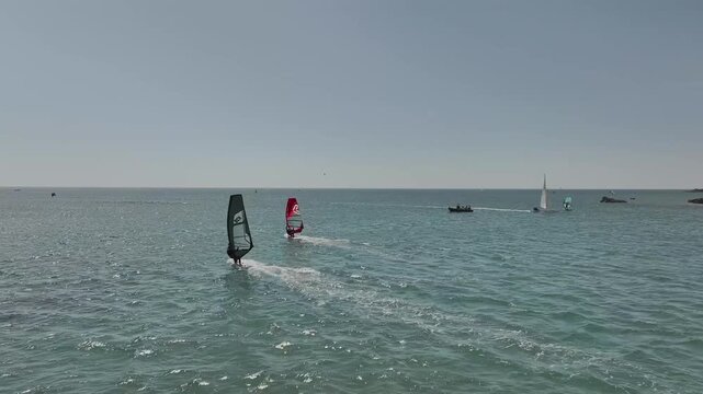 Windsurfers over Bantham Beach and River Avon from a drone, South Hams, Devon, England