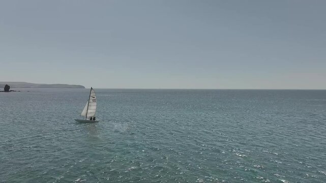 Catamaran over Bantham Beach and River Avon from a drone, South Hams, Devon, England