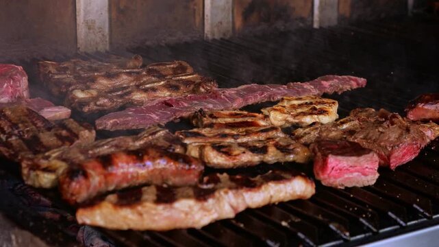 Close up of traditional Argentine asado barbecue grilling on outdoor restaurant parilla