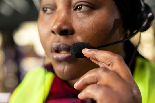 Black worker using headset for package tracking support