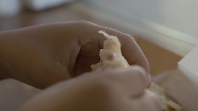 Child's hands breaking open a hot empanada