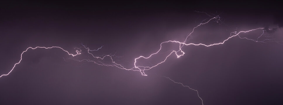 Very long lightning strike in a raiin storm at night