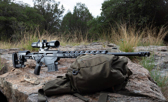 Highly accurate and adjustable rifle and scope on a boulder outdoors