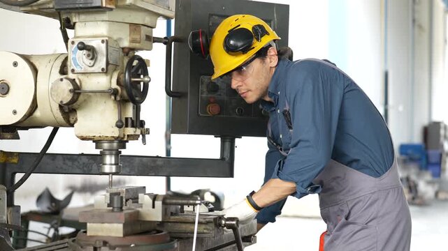 Industrial worker operating milling machine metal workshop, wearing protective equipment for precision manufacturing, machining metal parts as machine operator focused metalworking inside factory