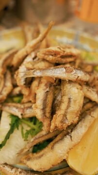 A typical Neapolitan dish of batter fried sardines served with lemon